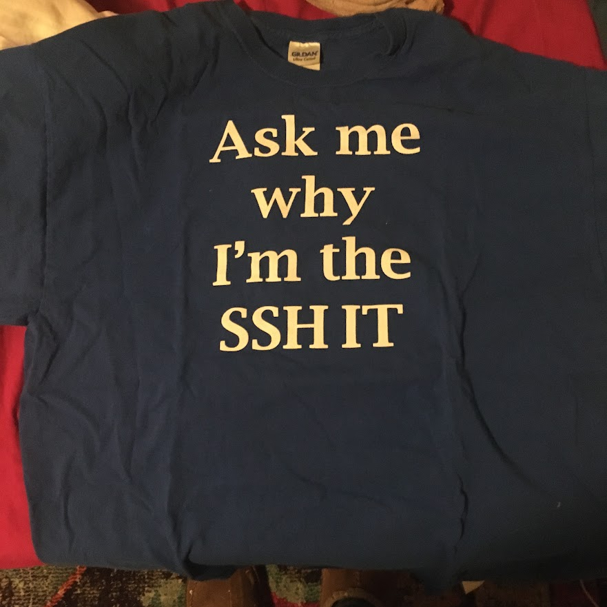 Official company T-shirt reading Ask me why I am the SSH IT